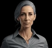 Portrait of a middle-aged woman with gray hair pulled back, wearing a gray collared shirt and a delicate necklace